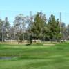 A sunny day view of a green at Augusta Ranch Golf Club.