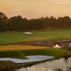 A view of green surrounded and bunker by water at Paradise Valley Park Golf Course