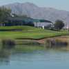 A view over the water of the clubhouse with mountains in background at Falcon Golf Club