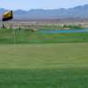 A view of the 17th green with a pond in background at Los Lagos Golf Club.