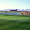 View of a green with the clubhouse in the background at El Rio Golf Club