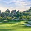 A view of a green protected by sand traps at Whisper Rock Golf Club