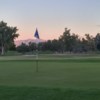 A sunset view of a green from Tres Rios Golf Course at Estrella Mountain Park.